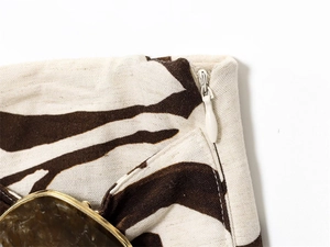 Detail of zebra print cotton fabric with invisible zipper and marble decorative button