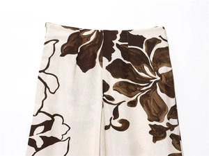 Macro shot of high-waist women's trousers with retro dark brown floral patterns