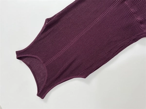 Detailed view of the ribbed knit texture and round neckline on a dark purple maxi dress