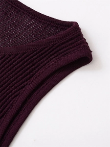 Detail of deep purple ribbed knit dress showing breathable mesh texture and fine stitching