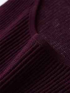Detail of burgundy ribbed knit neckline showing fine texture and elastic fabric material