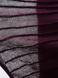 Macro shot of deep purple ribbed knit fabric with pleated texture and mesh detail