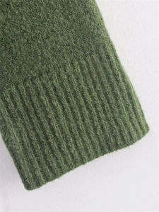 Detailed macro view of dark green ribbed knit cuffs with fluffy wool blend texture