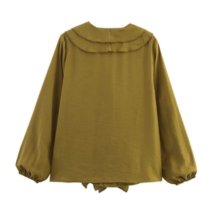 Close-up of mustard yellow long sleeve blouse featuring tiered ruffle collar and balloon sleeves
