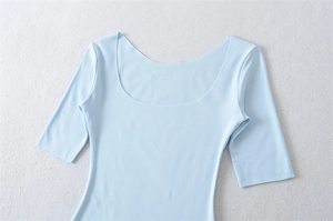 Detailed flat lay of a light blue U-neck cotton top showing soft knit fabric texture