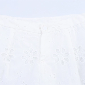 White low-rise shorts with intricate floral embroidery and hollow-out lace detailing