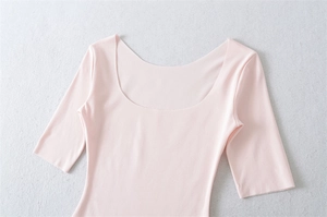 Detail of light pink slim fit top with wide U-neck and smooth stretch cotton fabric