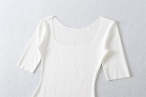 Detailed flat lay of white slim-fit cotton T-shirt featuring a deep U-neck and half sleeves