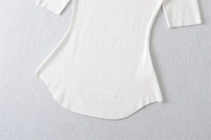 Detail shot of a white square neck t-shirt showing its unique curved hem and high elastic fabric