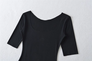 Detail of black slim-fit T-shirt showing the deep U-neckline and fine fabric texture