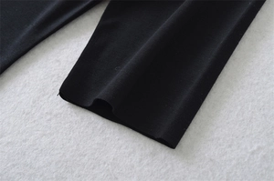 Close-up of fine knit texture and cuff stitching on white square neck cotton T-shirt