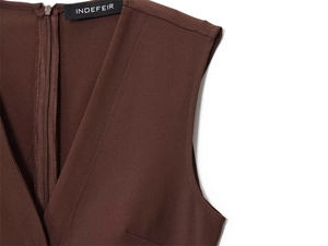 Detail of the deep brown crepe dress showing invisible zipper and deep V-neckline