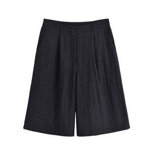 Detailed flat lay of black high-waisted wide-leg shorts with belt loops and pockets