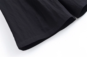 Detailed close-up showing the hem stitching and linen texture of the black blazer set fabric