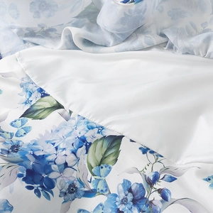 Detail of linen dress fabric with delicate blue hydrangea and butterfly floral prints