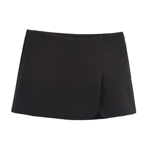 Detail of a black A-line wrap skort featuring an asymmetrical overlap design and smooth fabric