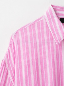 Detailed close-up of pink and white vertical stripe shirt collar and high-quality fabric
