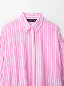 Close-up of pink striped shirt collar with detailed fabric texture and white buttons