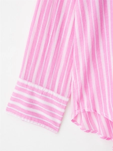Close-up of pink striped cotton shirt showing premium fabric texture and curved hem