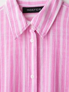 Close-up of pink striped shirt collar with breathable fabric texture and white buttons