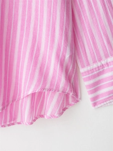 Detail of pink and white striped shirt showing cuff button and rounded hem texture