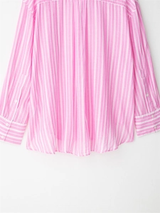 Detail of pink striped loose shirt with multi-button cuffs and curved hem design