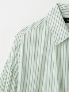 Detail of light green striped shirt collar and dropped shoulder with breathable fabric