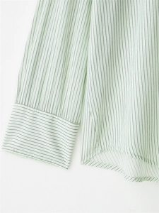 Detailed view of light mint green striped shirt cuff and hem in lightweight fabric