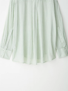 Detail showing back pleats and buttoned cuffs of the striped lightweight shirt