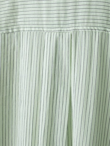 Detail of light green pinstripe shirt featuring cotton-linen texture and back pleat