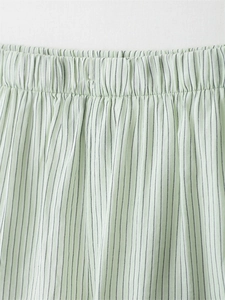 Detailed macro of the elastic waistband on light green striped cotton linen shorts