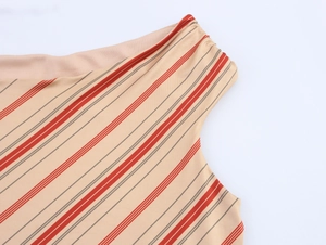 Detail view of beige off-shoulder dress with red diagonal stripes and drawstring gathers