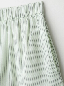 Detail of mint green striped shorts with elastic waistband and side pockets