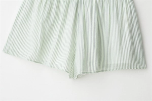 Close-up of light green striped shorts featuring soft fabric texture and hem detail