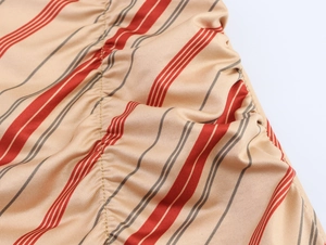 Macro detail of elastic striped fabric with fine ruched stitching and golden texture