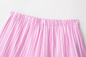 Close-up of pink and white vertical striped pajamas with wide elastic waistband detail