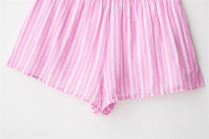 Detail view of pink and white vertical striped casual shorts with elastic waistband
