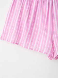 Detailed texture of pink striped cotton linen lounge shorts with elastic waistband