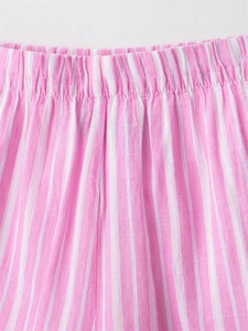 Close-up of pink and white striped pajama shorts featuring an elasticated waistband