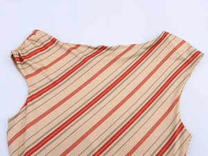 Close-up of ruched shoulder detail and red geometric stripes on off-shoulder dress