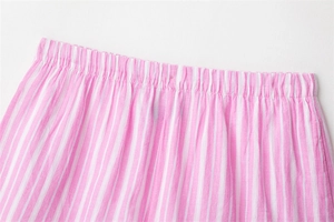 Close-up of pink and white striped pajama shorts featuring an elastic pleated waistband