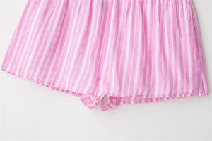 Detail view of pink and white striped pajama shorts showing fabric texture and hem