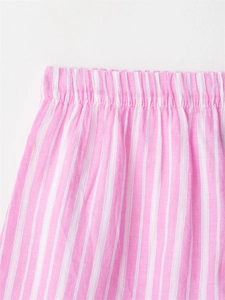 Detail view of the elastic waistband on pink and white striped pajama shorts