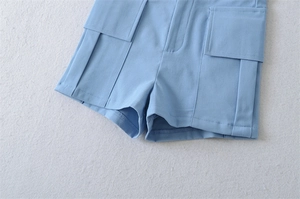 Detail of cargo pockets and hem on high-waist sky blue vintage utility shorts