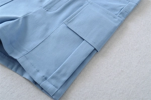 Detail of high-stretch denim shorts featuring a large utility pocket and reinforced stitching