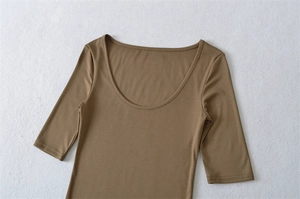 Detail of slim-fit brown low U-neck t-shirt featuring elastic ribbed fabric texture