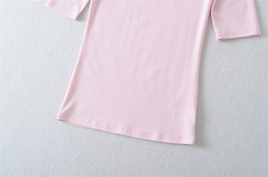 Detailed view of the double-needle hem stitching on light pink slim-fit jersey t-shirt