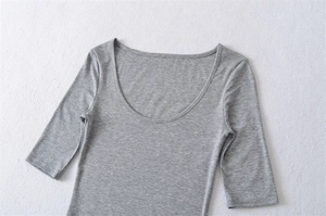 Detailed macro view of gray slim fit ribbed knit t-shirt fabric with scoop neckline