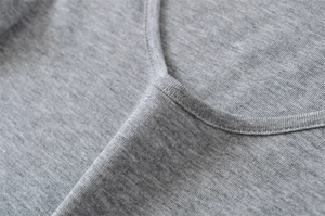 Close-up of grey knit T-shirt neckline showing reinforced double-needle stitching detail