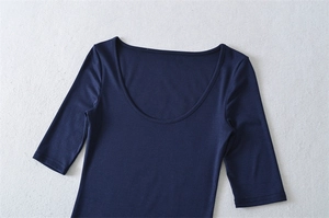 Detail shot of the deep blue U-neck and shoulder seams of this slim fit jersey top